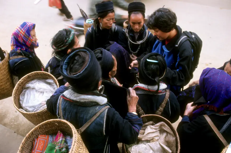 Michelle innocently asks one woman how much an embroidered pillowcase costs and instantly, is surrounded by a flock of hilltribe women trying to make a sale.