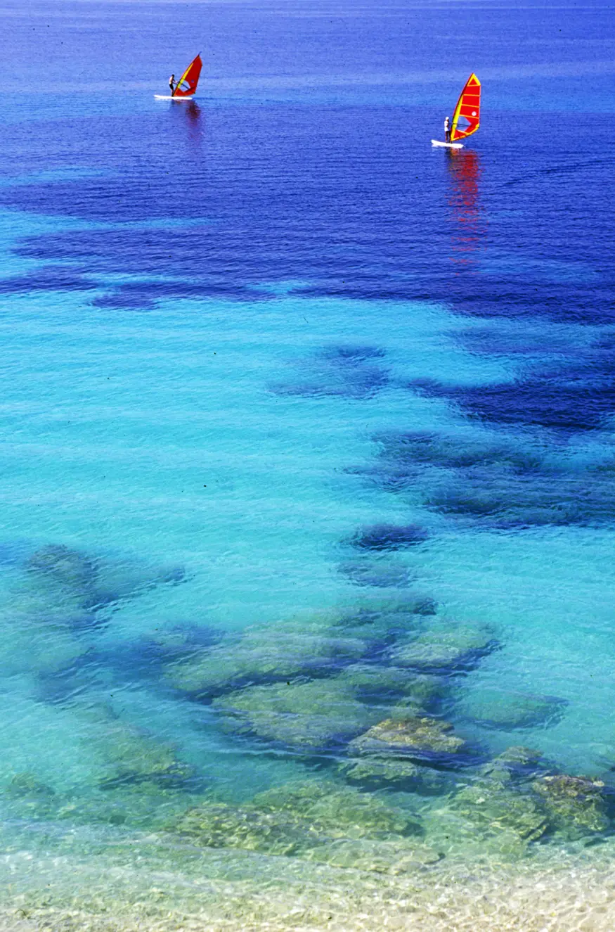 Two windsurfers float on the Dalmatian coast's blue water near the resort town of Bol on the island of Brac (Brach).