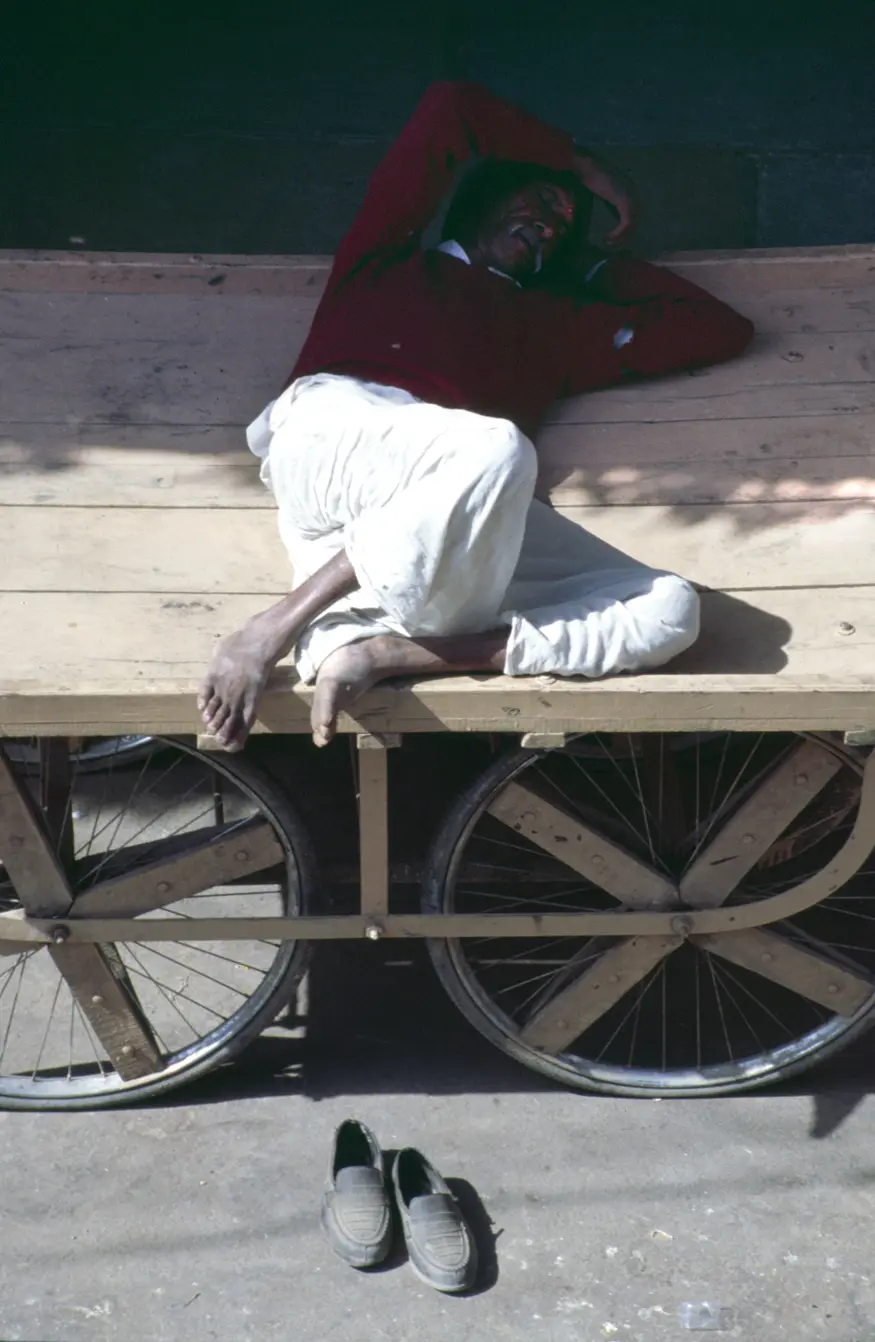 A man takes an afternoon nap on his push cart in Pushkar.
