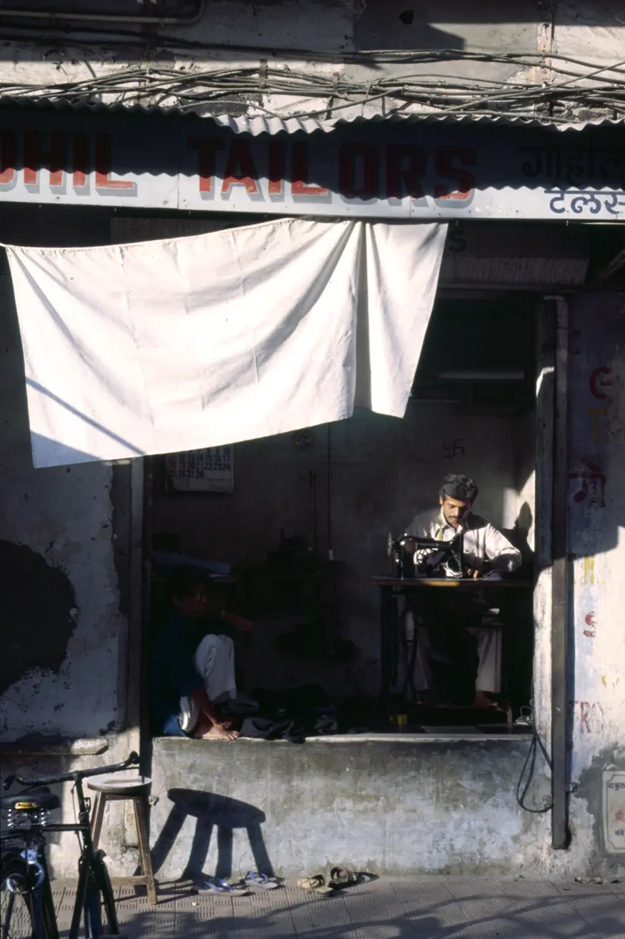 A tailor stitches clothes in India's Mt. Abu.