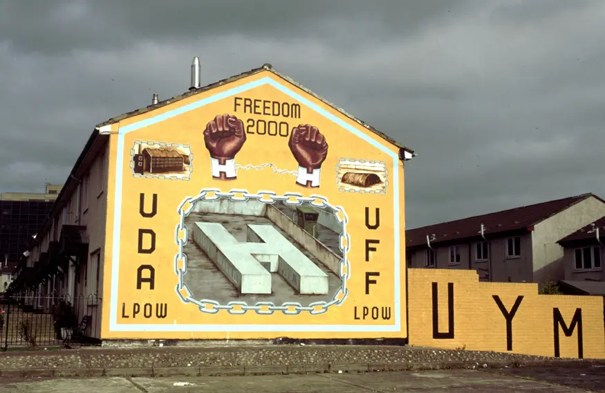 Mural in Protestant Shankill Road area of Belfast honoring the Ulster Defence Association (UDA) and Ulster Freedom Fighters (UFF). 
Inscription reads, ""Freedom 2000 / UDA LPOW / UFF LPOW.""