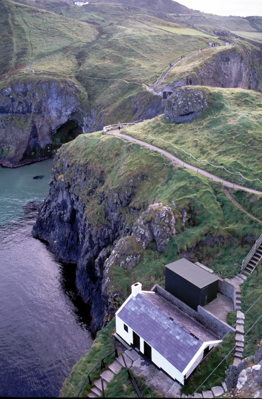 A small home on the Antrim Country north coast island of Carrick-a-rede.  The island is connected to the mainland by a small rope bridge that dangles high over the water.