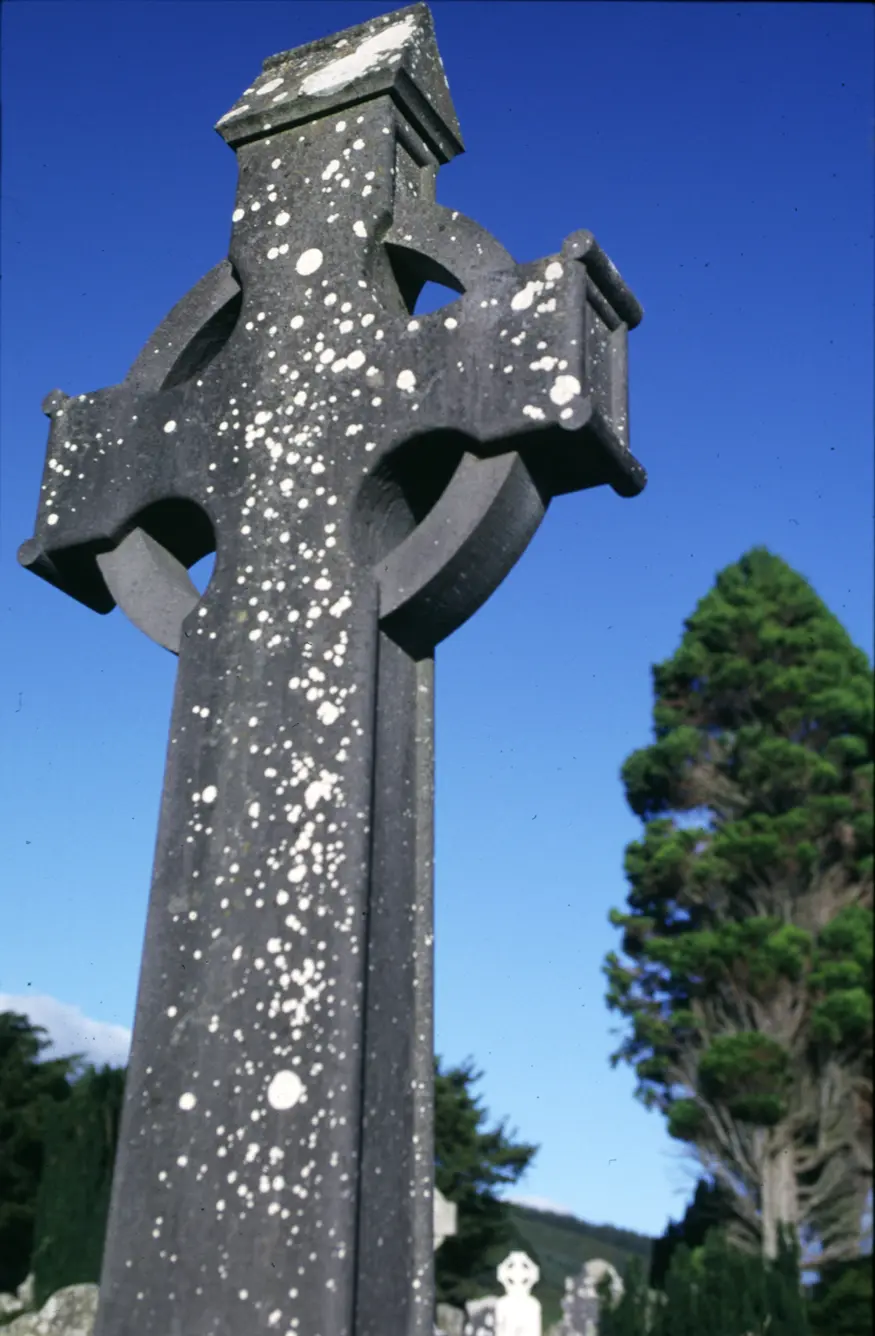 A Celtic cross headstone in a graveyard near the Glendalough Monastery. The monastery was founded during the sixth century and remained active until the sixteenth century.