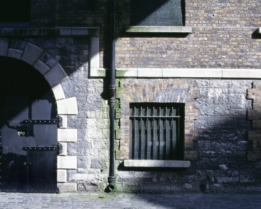 Light filters down on a doorway in the Guinness brewery, a 64 acre complex founded in 1759. Two and a half million pints of Guinness are brewed behind these doors every day.