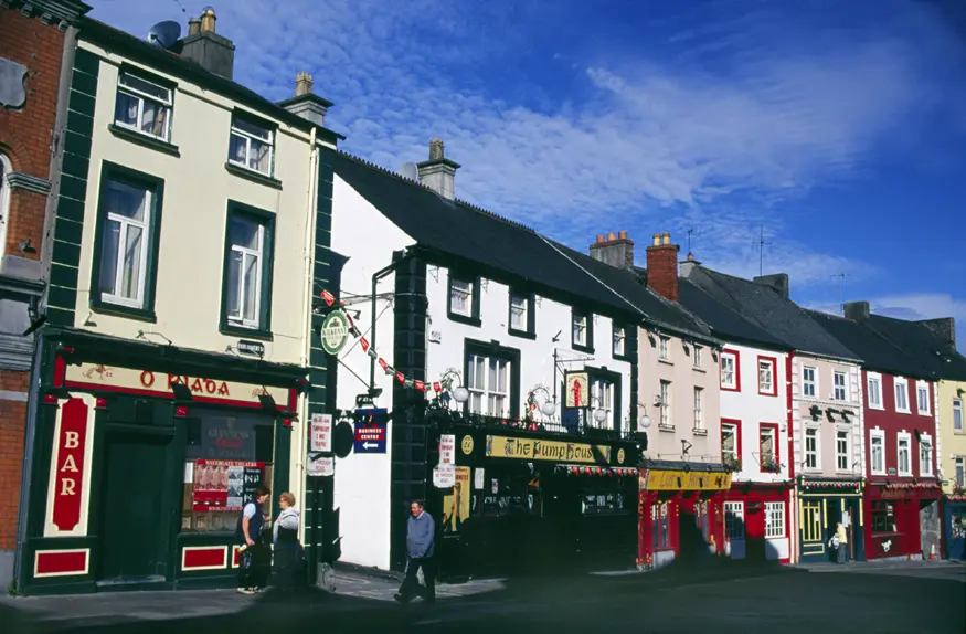 Traditional Irish pubs line a street in the quaint town of Kilkenny.