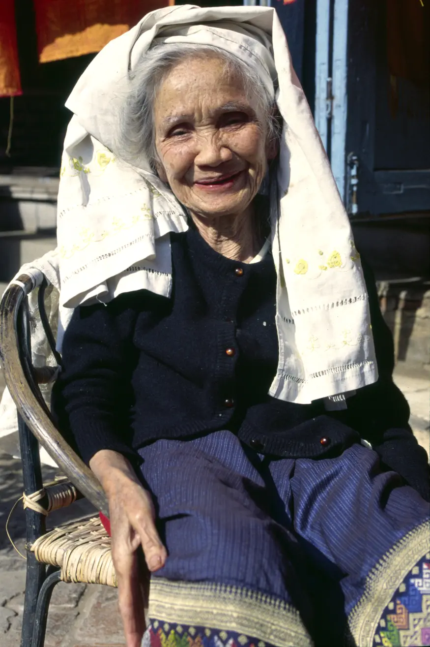 An old woman in Luang Prabang, Laos, relaxes in a chair.