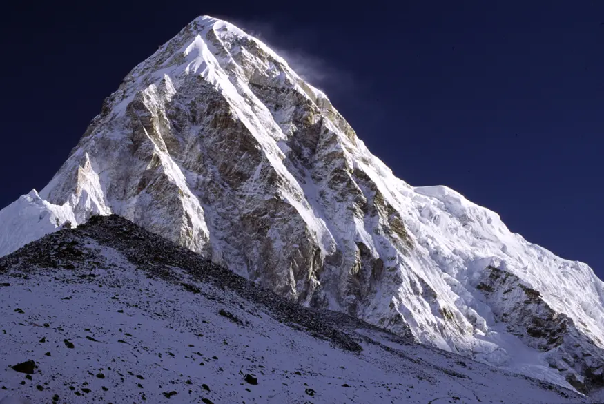 The majestic peak of Pumori stands at 7161 meters (23,494 feet), rising almost 1500 meters higher than the peak of Kala Pattar below it.