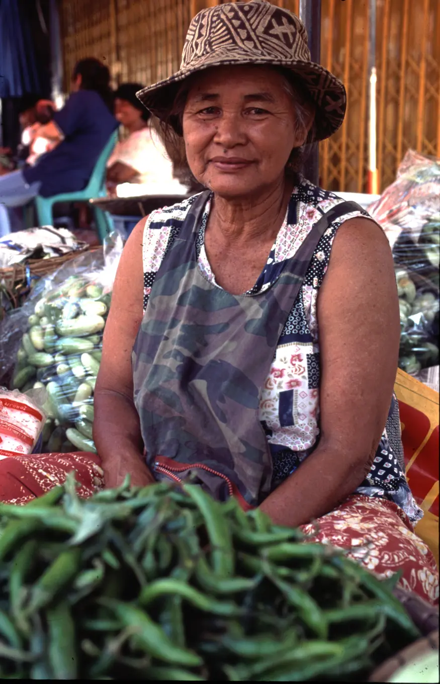 A Thai woman sells vegetables on street in Sukhothai.