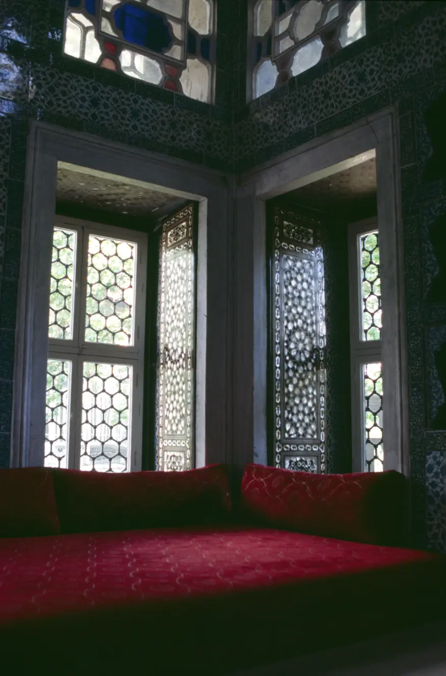 Sun filters across a red couch and mother-of-pearl doors in the Topkapi Palace, Istanbul's home of the sultans.