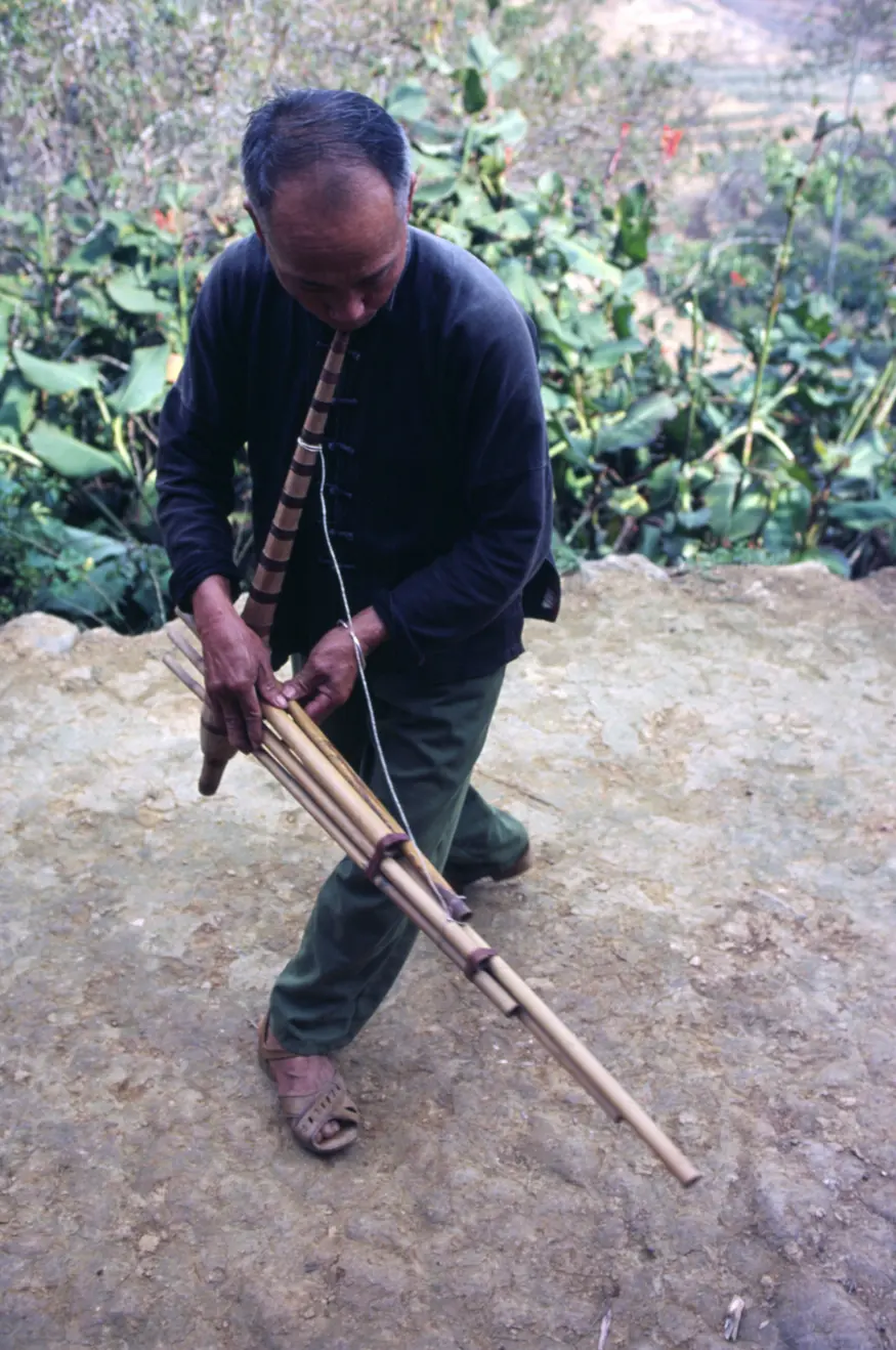 A hilltribe musician in Bac Ha, northern Vietnam, plays a haunting tune on his home-made instrument.