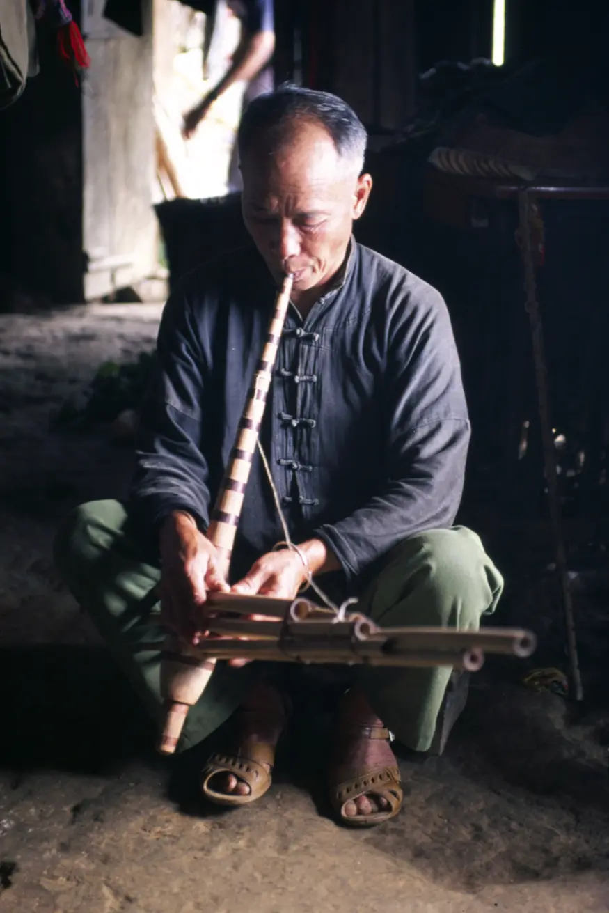 A hilltribe musician in Bac Ha, northern Vietnam, plays a haunting tune on his home-made instrument.
